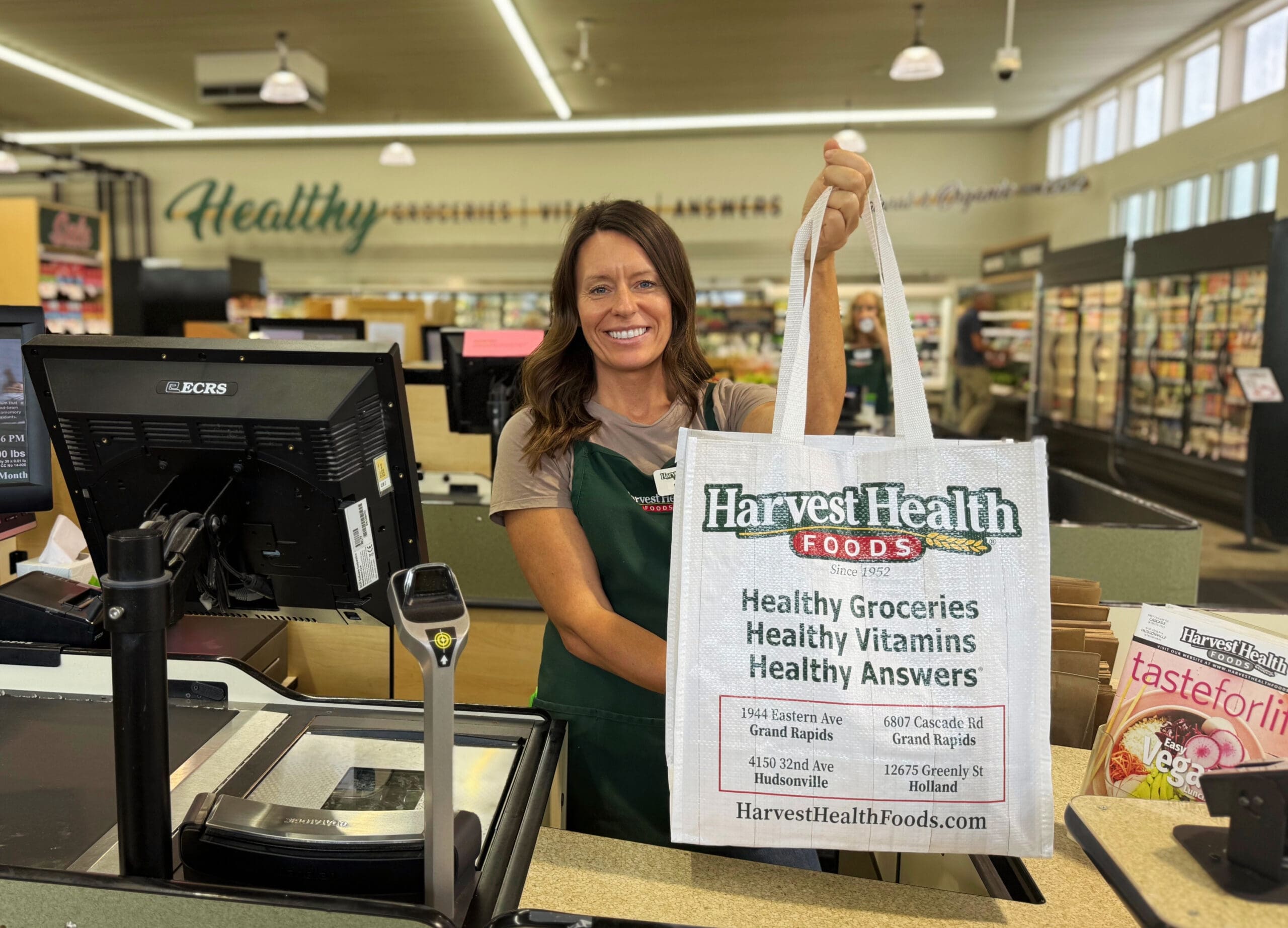Cashier handing bag of groceries over to customer